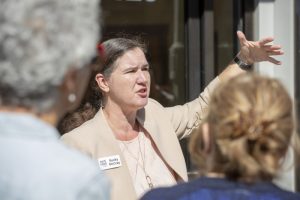 Rural speaker Becky McCray leads a group discussion in front of a small town downtown building