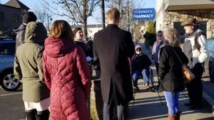 Becky McCray leads a group of people walking through a downtown in Cowlitz County, Washington