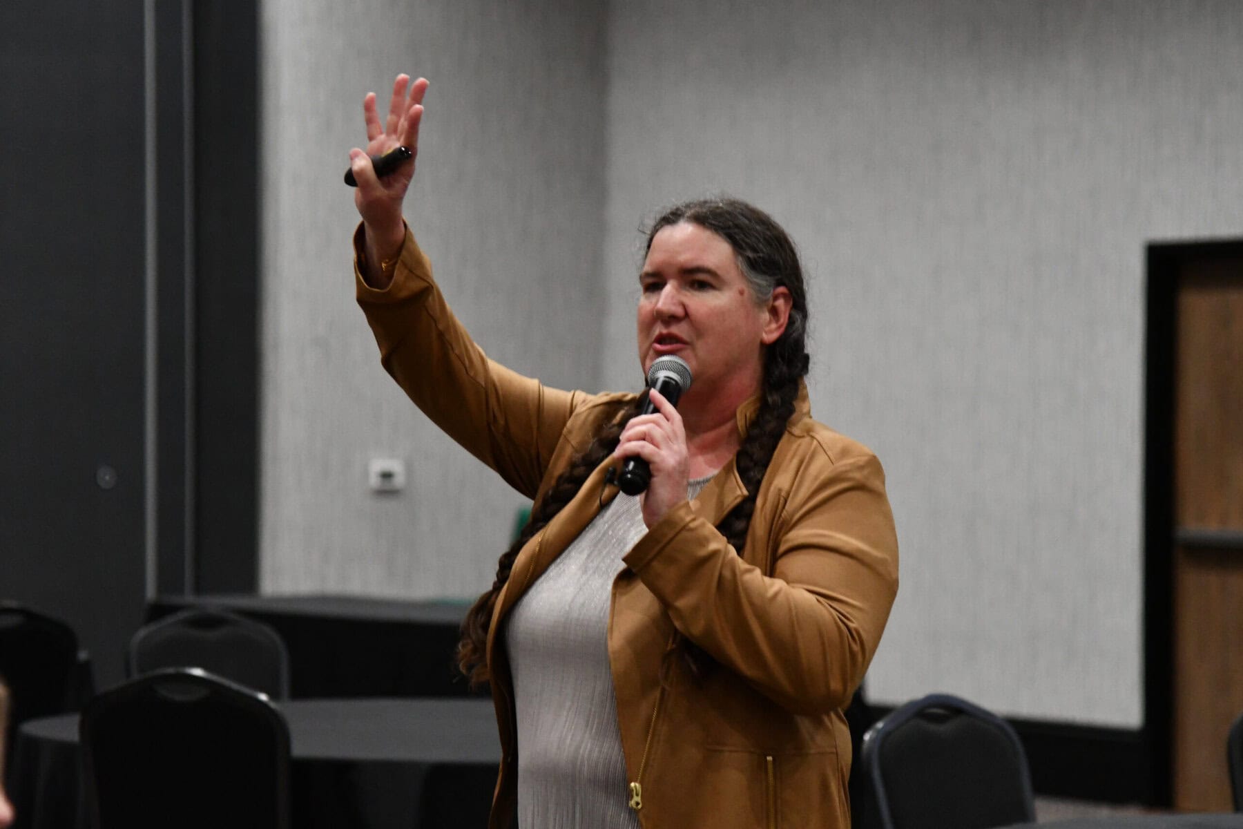 Becky McCray speaking with one arm raised