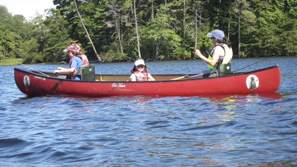 A family fishing from a canoe
