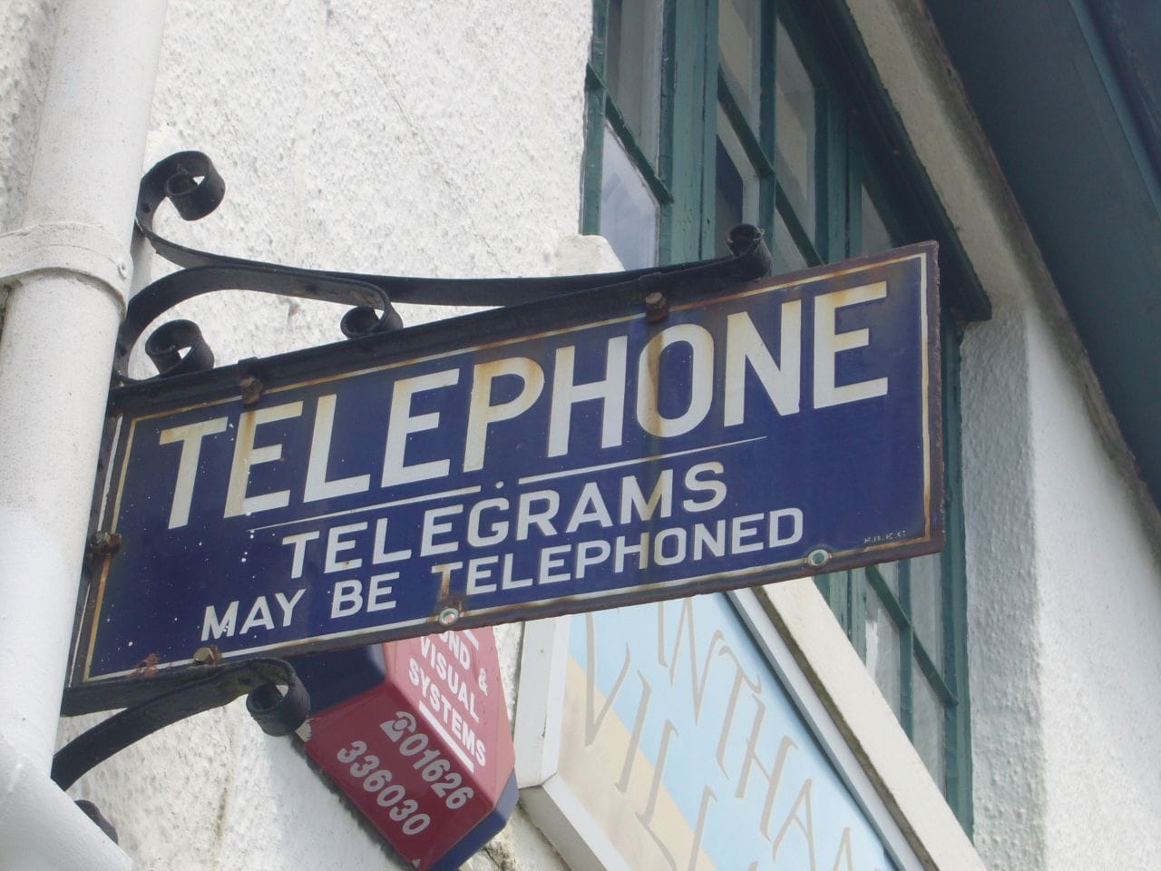 A vintage sign on a downtown building says, "Telephone. Telegrams may be telephoned."