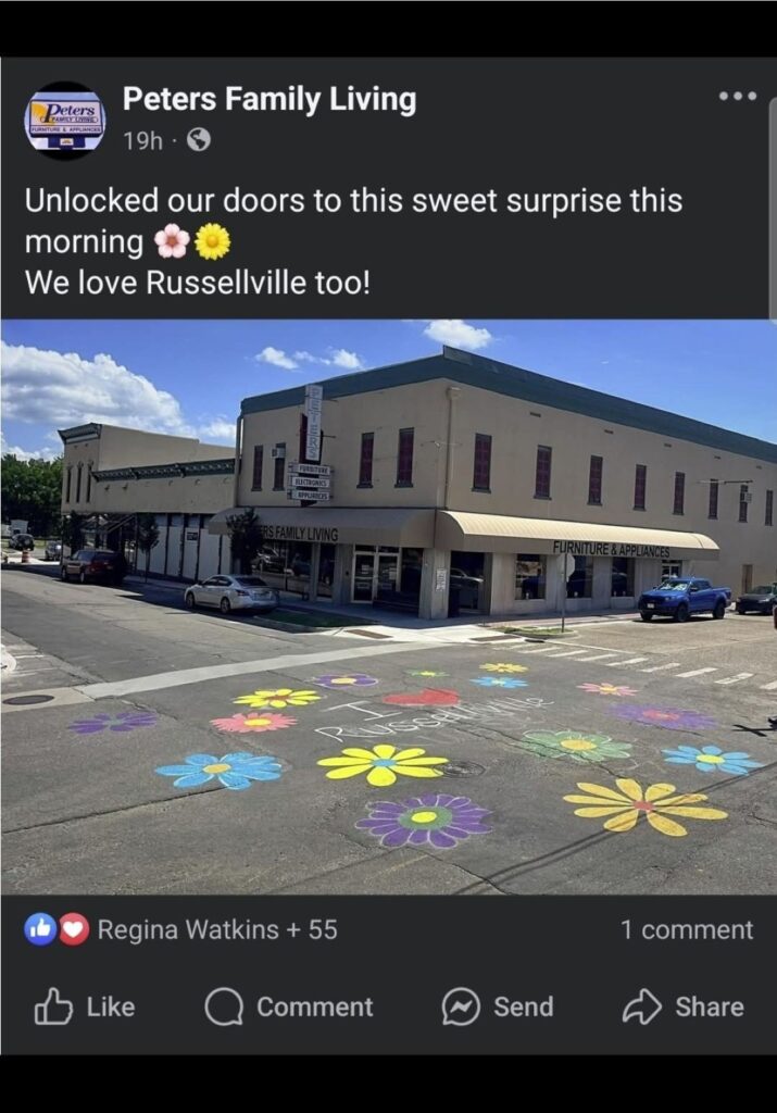 Facebook photo of the painted intersection from across the street with the business in the background