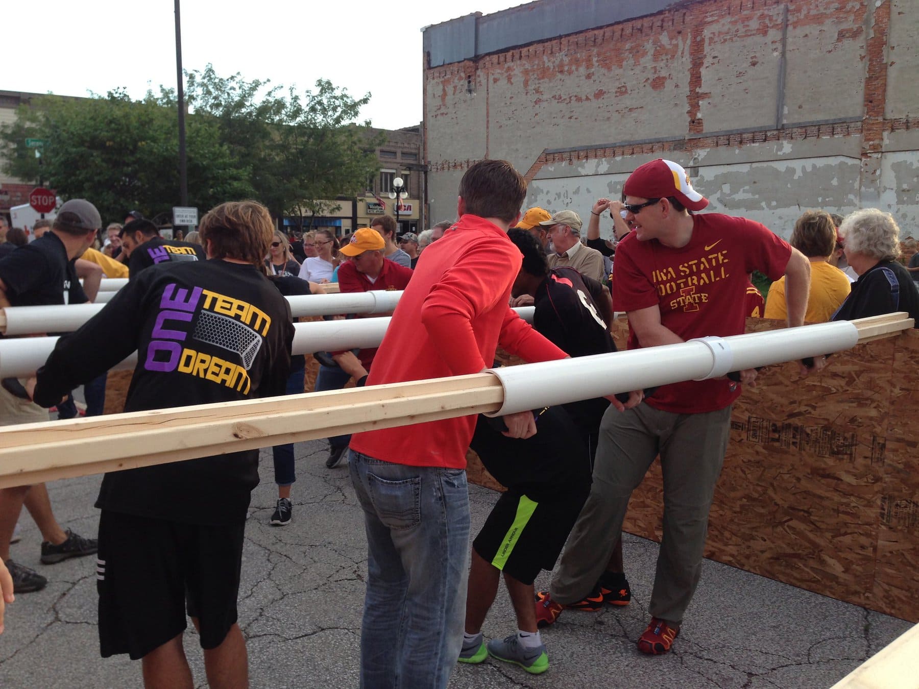 A diverse group of people playing human foosball, read ahead for detailed description